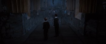 Movie still from “Harry Potter and the Order of the Phoenix” (2007), directed by David Yates – Two young men in suits are standing in a room; Wide shot, High angle