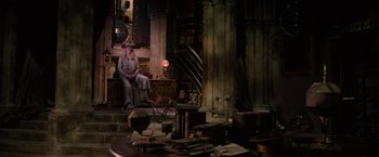 Movie still from “Harry Potter and the Order of the Phoenix” (2007), directed by David Yates – An old man sitting on a chair in a room; Wide shot, High angle
