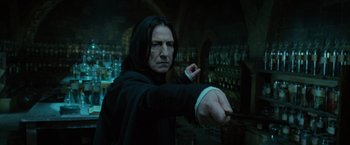Movie still from “Harry Potter and the Order of the Phoenix” (2007), directed by David Yates – A man with long black hair is pointing at the camera; Close Up shot, Low angle