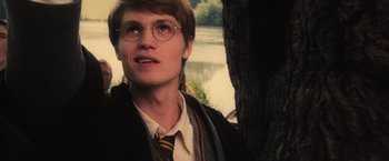 Movie still from “Harry Potter and the Order of the Phoenix” (2007), directed by David Yates – A young man wearing glasses and wearing a tie; Close Up shot, Low angle