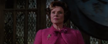Movie still from “Harry Potter and the Order of the Phoenix” (2007), directed by David Yates – A woman in a pink jacket and a bow tie; Close Up shot, Low angle