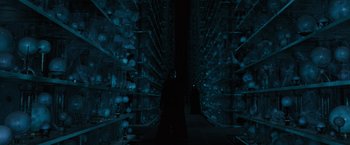 Movie still from “Harry Potter and the Order of the Phoenix” (2007), directed by David Yates – A person standing in front of a bunch of shelving; Wide shot, Over the shoulder angle