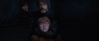 Movie still from “Harry Potter and the Order of the Phoenix” (2007), directed by David Yates – A man and a boy are sitting next to each other; Close Up shot, Over the shoulder angle