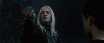 Movie still from “Harry Potter and the Order of the Phoenix” (2007), directed by David Yates – A man with long white hair holding a cell phone; Close Up shot, Low angle