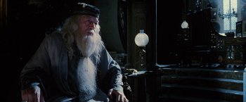 Movie still from “Harry Potter and the Order of the Phoenix” (2007), directed by David Yates – An old man sitting in front of an old lamp; Medium shot, High angle