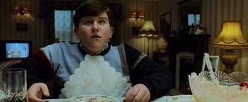 Movie still from “Harry Potter and the Prisoner of Azkaban” (2004), directed by Alfonso Cuarón – A young man sitting at a table with a plate in front of him; Close Up shot, Low angle