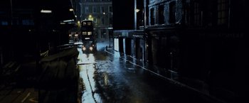Movie still from “Harry Potter and the Prisoner of Azkaban” (2004), directed by Alfonso Cuarón – A bus is driving down a wet street at night; Extreme Wide shot, High angle