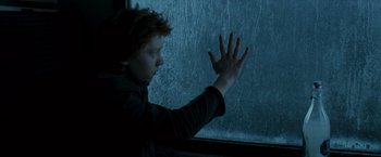 Movie still from “Harry Potter and the Prisoner of Azkaban” (2004), directed by Alfonso Cuarón – A young boy standing in front of a window; Medium shot, High angle