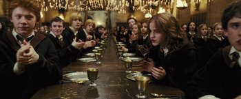 Movie still from “Harry Potter and the Prisoner of Azkaban” (2004), directed by Alfonso Cuarón – A group of people sitting at a long wooden table; Medium shot, High angle