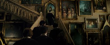 Movie still from “Harry Potter and the Prisoner of Azkaban” (2004), directed by Alfonso Cuarón – A group of people sitting on some stairs; Wide shot, Low angle