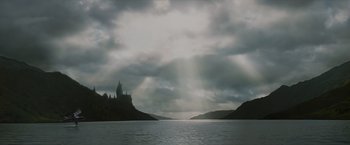 Movie still from “Harry Potter and the Prisoner of Azkaban” (2004), directed by Alfonso Cuarón – A view of a castle in the middle of a body of water; Extreme Wide shot, Low angle