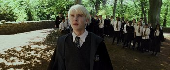 Movie still from “Harry Potter and the Prisoner of Azkaban” (2004), directed by Alfonso Cuarón – A man with blonde hair wearing a black shirt; Medium shot, Low angle