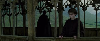 Movie still from “Harry Potter and the Prisoner of Azkaban” (2004), directed by Alfonso Cuarón – A man standing in front of a window with another man behind it; Medium shot, Over the shoulder angle