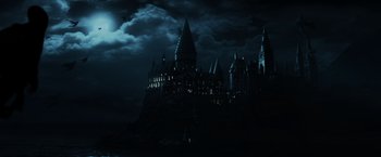 Movie still from “Harry Potter and the Prisoner of Azkaban” (2004), directed by Alfonso Cuarón – A castle is lit up at night with a full moon; Extreme Wide shot, High angle