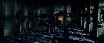 Movie still from “Harry Potter and the Prisoner of Azkaban” (2004), directed by Alfonso Cuarón – A group of people in a room covered in blankets; Extreme Wide shot, High angle