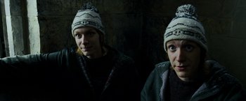 Movie still from “Harry Potter and the Prisoner of Azkaban” (2004), directed by Alfonso Cuarón – Two young people wearing winter hats in the dark; Close Up shot, High angle
