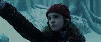 Movie still from “Harry Potter and the Prisoner of Azkaban” (2004), directed by Alfonso Cuarón – A young girl wearing a red hat in the snow; Close Up shot, Low angle