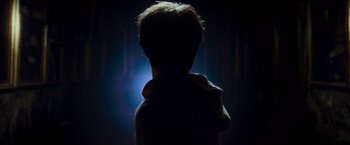 Movie still from “Harry Potter and the Prisoner of Azkaban” (2004), directed by Alfonso Cuarón – A person is standing in the dark with their back to the camera; Close Up shot, Low angle