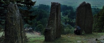 Movie still from “Harry Potter and the Prisoner of Azkaban” (2004), directed by Alfonso Cuarón – A large rock in the middle of a green field; Extreme Wide shot, High angle