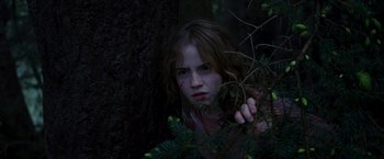 Movie still from “Harry Potter and the Prisoner of Azkaban” (2004), directed by Alfonso Cuarón – A young girl in the woods touching a tree branch; Close Up shot, Low angle