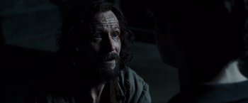 Movie still from “Harry Potter and the Prisoner of Azkaban” (2004), directed by Alfonso Cuarón – A man with a long beard is looking at the camera; Close Up shot, Over the shoulder angle