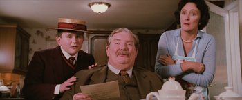 Movie still from “Harry Potter and the Sorcerer's Stone” (2001), directed by Chris Columbus – An older man sitting at a table with two other people; Close Up shot, Over the shoulder angle
