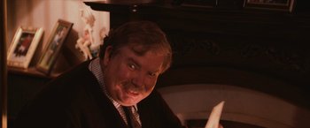 Movie still from “Harry Potter and the Sorcerer's Stone” (2001), directed by Chris Columbus – A person wearing a suit and tie; Close Up shot, Over the shoulder angle