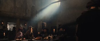 Movie still from “Harry Potter and the Sorcerer's Stone” (2001), directed by Chris Columbus – A group of people sitting around a table with candles on it; Wide shot, Low angle