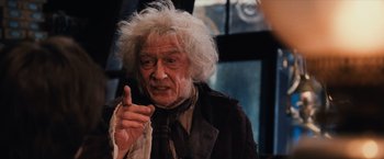 Movie still from “Harry Potter and the Sorcerer's Stone” (2001), directed by Chris Columbus – An old man with a white hair pointing at the camera; Close Up shot, Over the shoulder angle