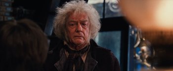 Movie still from “Harry Potter and the Sorcerer's Stone” (2001), directed by Chris Columbus – An older man with white hair is looking at the camera; Close Up shot, Low angle