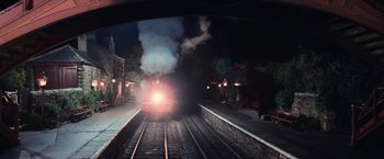 Movie still from “Harry Potter and the Sorcerer's Stone” (2001), directed by Chris Columbus – A train traveling down train tracks at night; Extreme Wide shot, High angle