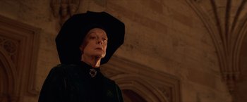 Movie still from “Harry Potter and the Sorcerer's Stone” (2001), directed by Chris Columbus – An older woman wearing a black hat and a black dress; Close Up shot, Low angle