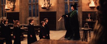 Movie still from “Harry Potter and the Sorcerer's Stone” (2001), directed by Chris Columbus – A group of young people standing in front of a woman; Wide shot, High angle