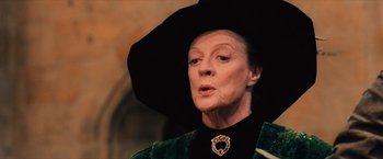 Movie still from “Harry Potter and the Sorcerer's Stone” (2001), directed by Chris Columbus – An older woman wearing a black hat and a green jacket; Close Up shot, Low angle