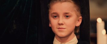 Movie still from “Harry Potter and the Sorcerer's Stone” (2001), directed by Chris Columbus – A person wearing a shirt and bow tie; Close Up shot, High angle