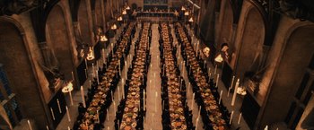 Movie still from “Harry Potter and the Sorcerer's Stone” (2001), directed by Chris Columbus – A long table filled with lots of plates of food; Extreme Wide shot, High angle