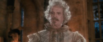 Movie still from “Harry Potter and the Sorcerer's Stone” (2001), directed by Chris Columbus – A person wearing a suit and tie; Close Up shot, Over the shoulder angle