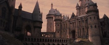 Movie still from “Harry Potter and the Sorcerer's Stone” (2001), directed by Chris Columbus – A castle like building that has a clock tower on top of it; Extreme Wide shot, Low angle