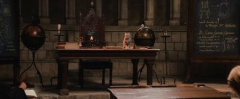 Movie still from “Harry Potter and the Sorcerer's Stone” (2001), directed by Chris Columbus – Two cats sitting on a table in a room; Wide shot, High angle