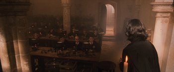 Movie still from “Harry Potter and the Sorcerer's Stone” (2001), directed by Chris Columbus – A group of people sitting at a table in a room; Wide shot, High angle