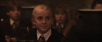 Movie still from “Harry Potter and the Sorcerer's Stone” (2001), directed by Chris Columbus – A young boy and a young girl in school uniforms; Close Up shot, High angle