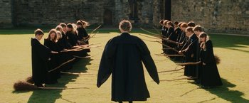 Movie still from “Harry Potter and the Sorcerer's Stone” (2001), directed by Chris Columbus – A group of people standing in the middle of a field; Wide shot, High angle