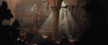Movie still from “Harry Potter and the Sorcerer's Stone” (2001), directed by Chris Columbus – A group of people sitting in a room with candles; Wide shot, High angle