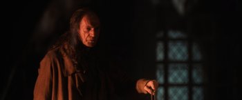 Movie still from “Harry Potter and the Sorcerer's Stone” (2001), directed by Chris Columbus – A man with long black hair holding a cane; Close Up shot, Low angle