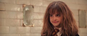 Movie still from “Harry Potter and the Sorcerer's Stone” (2001), directed by Chris Columbus – A young girl in a harry potter uniform; Close Up shot, High angle