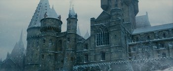 Movie still from “Harry Potter and the Sorcerer's Stone” (2001), directed by Chris Columbus – A castle with a lot of windows and a lot of snow on the roof; Extreme Wide shot, Low angle