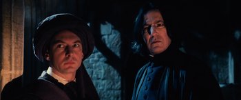 Movie still from “Harry Potter and the Sorcerer's Stone” (2001), directed by Chris Columbus – Two people standing next to each other near a stone wall; Close Up shot, Low angle