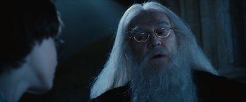 Movie still from “Harry Potter and the Sorcerer's Stone” (2001), directed by Chris Columbus – An old man with long white hair wearing glasses; Close Up shot, Over the shoulder angle