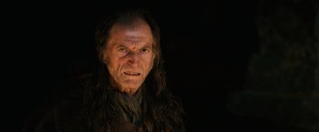 Movie still from “Harry Potter and the Sorcerer's Stone” (2001), directed by Chris Columbus – An old man with long hair is looking at the camera; Close Up shot, Over the shoulder angle