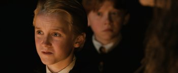 Movie still from “Harry Potter and the Sorcerer's Stone” (2001), directed by Chris Columbus – Two young boys in suits and ties looking at the camera; Close Up shot, Low angle